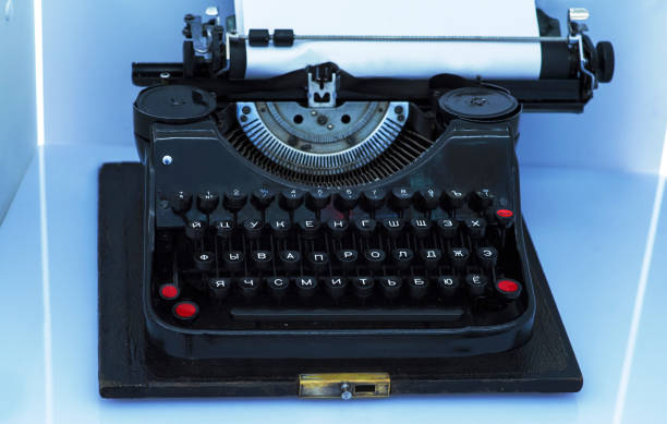 istock Old vintage typewriter with a blank sheet of paper inserted 1214669653