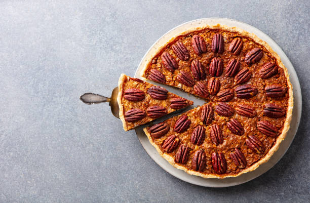 istock Pecan nut pie, on a plate. Grey background. Copy space. Top view. 1214671444