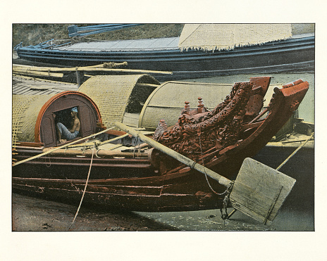 Group of men and equipment aboard a scow boat on the Athabasca River in Alberta, Canada. Vintage photograph ca. 1915.