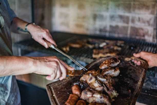 istock Two men serving meat for lunch, asado 1214673492