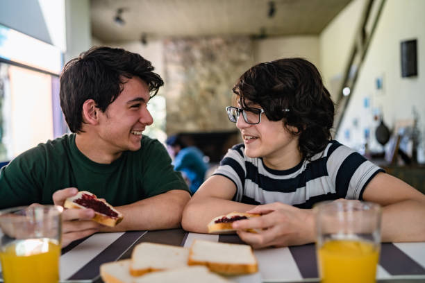 Teenagers having breakfast Two male teenagers having breakfast together. spanish breakfast stock pictures, royalty-free photos & images