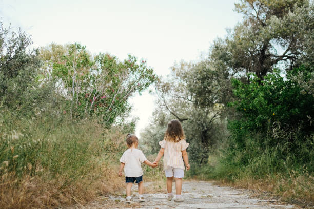 istock Two little girls having fun and running together 1214675274