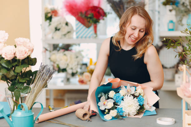 istock Florist makes a bouquet in a flower boutique 1214675286