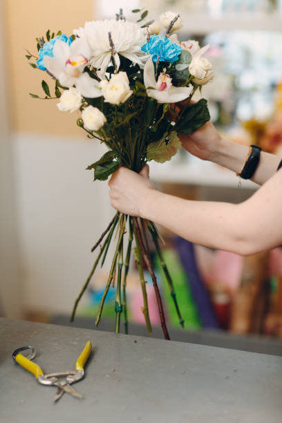 istock Florist makes a bouquet in a flower boutique 1214675511