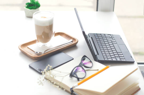 istock A table in a bright cafe with latte and freelancer work details. 1214677094