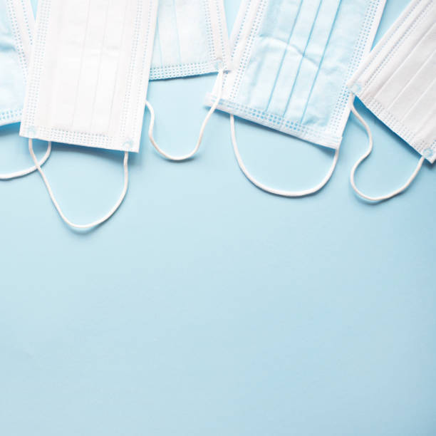 istock Medical masks on a light blue background. 1214679007