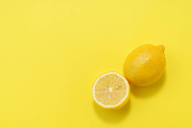 istock Sliced lemon fruit isolated on color background 1214679409