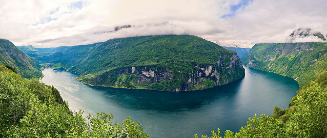 panoramic view of the fjord from the top of the mountains, a winding sea path between high Norwegian cliffs