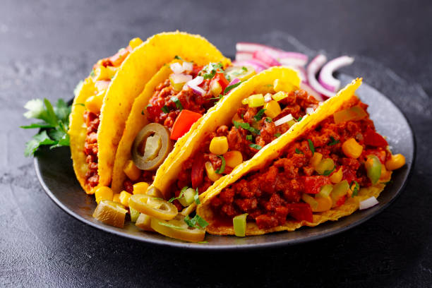 istock Taco with beef, Mexican traditional cuisine. Dark background. Close up. 1214682843