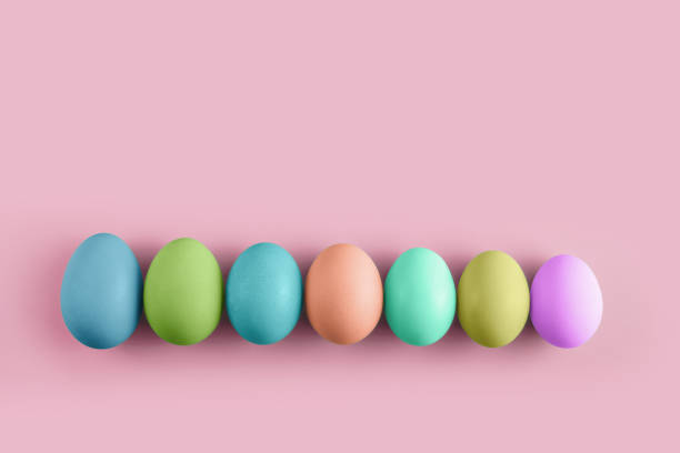 istock Seven coloured chicken eggs in row on a pink background. Minimal Happy Easter concept decoration. 1214682870