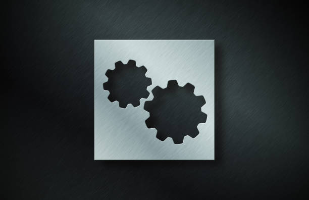 Gray Metal Plate With Gear Symbol On Dark Metallic Background. Horizontal composition with copy space.