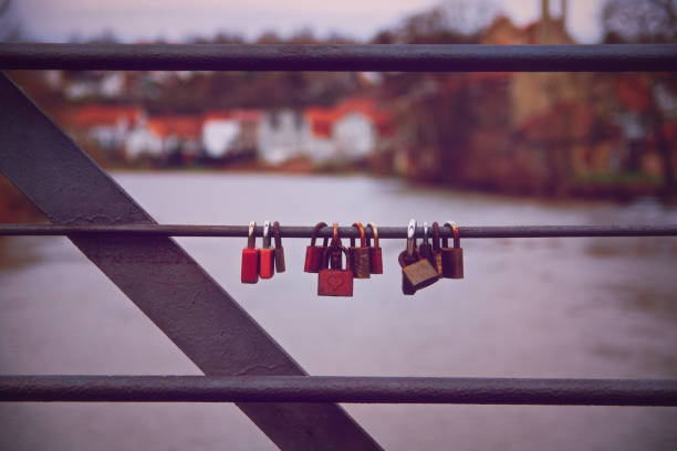istock Romantic lover padlocks on a bridge in a symmetric row 1214683987
