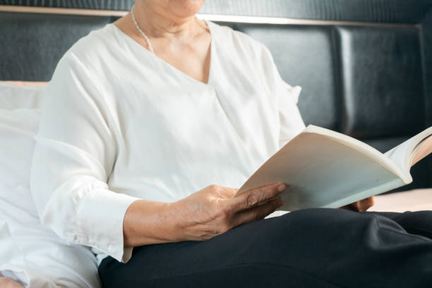 istock Covid-19 quarantine activity for senior woman read a book stay home to avoid risk 1214684943