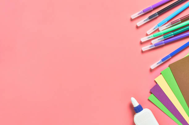 istock Accessories for child leisure and intellectual develop lies on pink desk. Copy space. Top view 1214687018