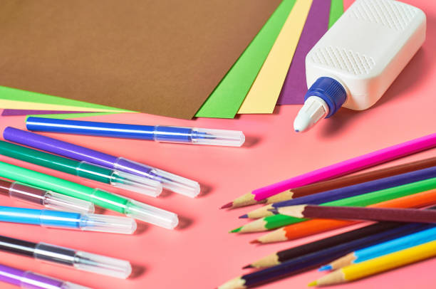 istock Accessories for child leisure and intellectual develop lies on pink desk 1214687031