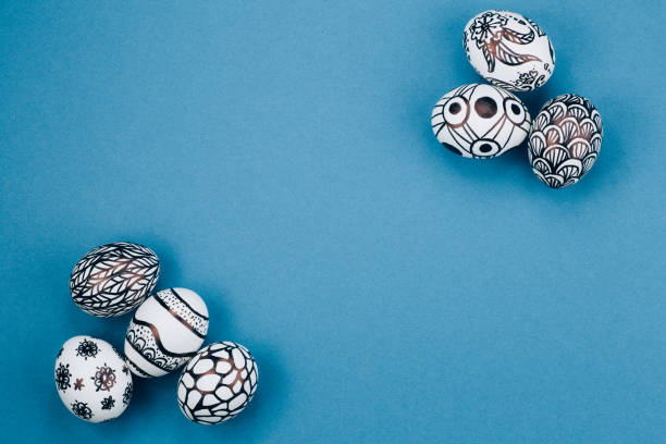 istock Easter eggs are painted in black and white lie in the corners diagonally 1214687049