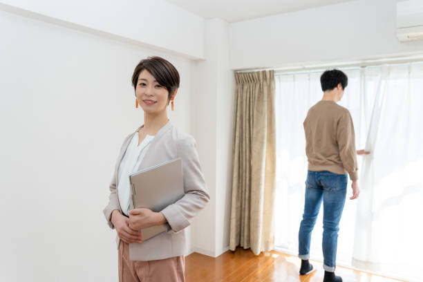 istock Asian real estate agent with clients 1214687245