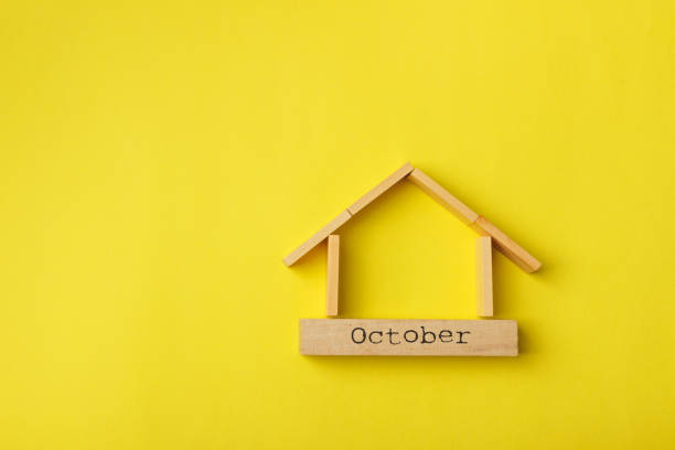 istock house shaped wooden logs on the yellow background 1214687279