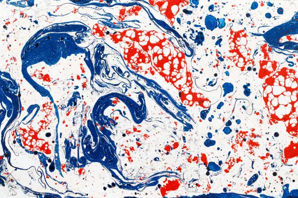 Abstract futuristic creative background. Mixing blue and red paints. Drops.  Liquid paint.