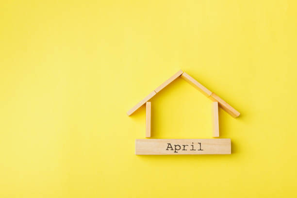 istock house shaped wooden logs on the yellow background 1214687352