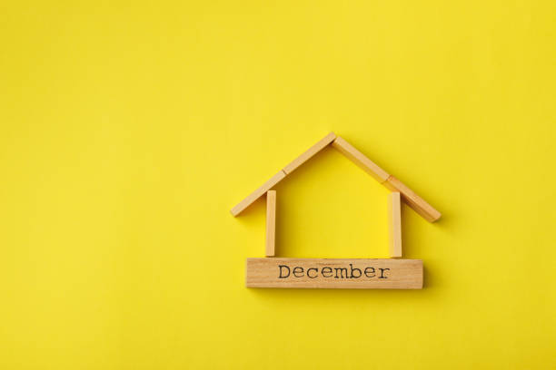 istock house shaped wooden logs on the yellow background 1214687377