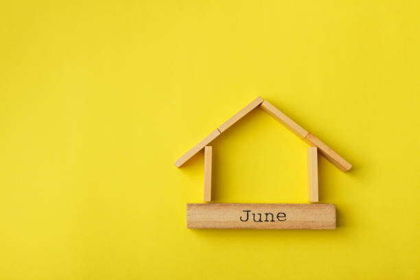 istock house shaped wooden logs on the yellow background 1214687398