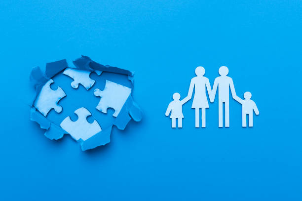 istock World Autism Awareness, concept with puzzle or jigsaw pattern in paper cut hole. Blue background 1214688639