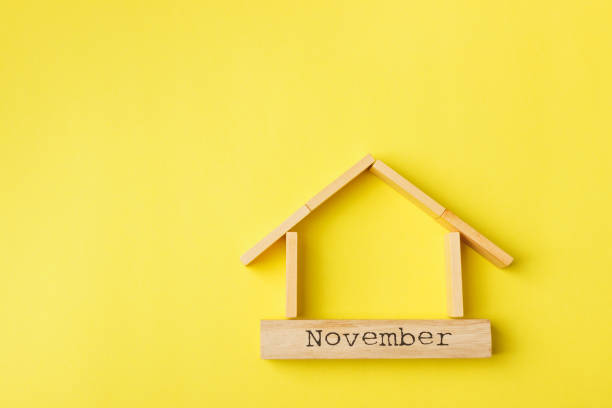 istock house shaped wooden logs on the yellow background 1214688817