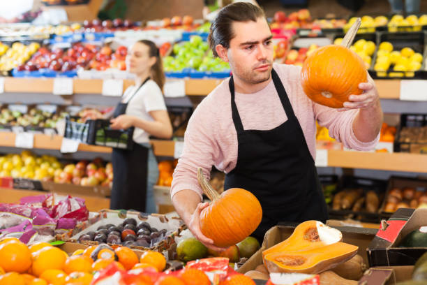 istock Glad man with pumpkin in hands 1214691169