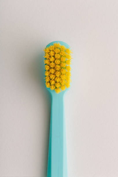 istock Yellow bristle toothbrush macro shot 1214692158