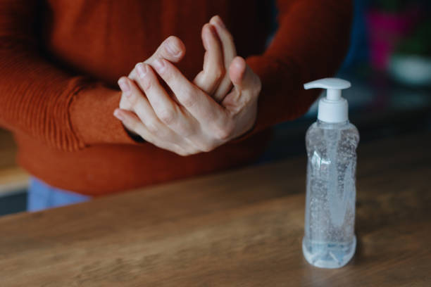 istock Man using hand sanitizer to clean his hands 1214692167