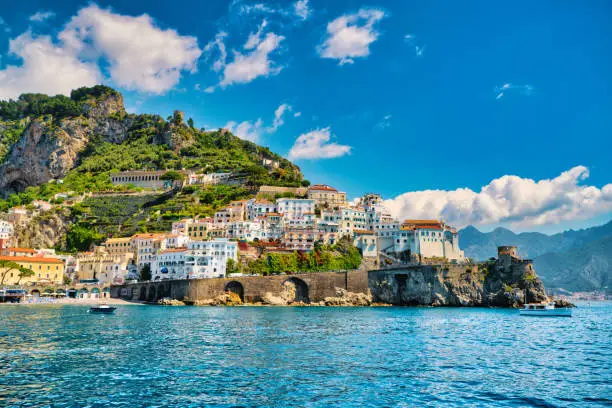 Looking at the famous village of Amalfi on the Amalfi coast. Many of the small villages along the Amalfi coastline are hundreds of meters above sea level, because of the geographical reasons. The Amalfi coast is a stretch of coastline on the northern coast of the Salerno Gulf on the Tyrrhenian Sea, located in the Province of Salerno of southern Italy. The Amalfi Coast is a popular tourist destination for the region and Italy as a whole, attracting thousands of tourists annually. In 1997, the Amalfi Coast was listed as a UNESCO World Heritage Site.