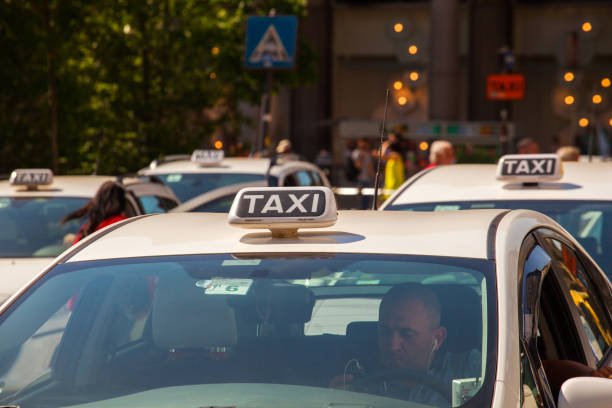 MILAN, ITALY - MAY, 15: Taxi parking in Milan street waiting for passengers on May 15, 2015