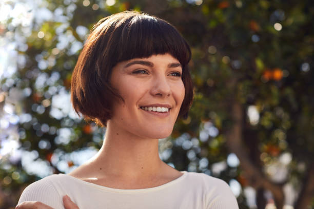 istock Smiling young woman standing alone outdoors after exercising 1214694110