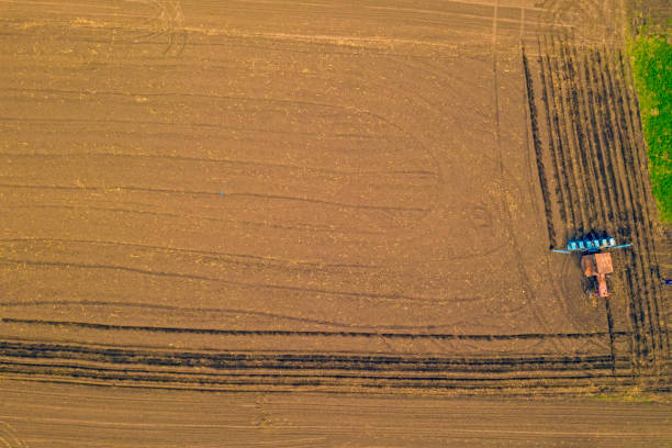 istock Above view of traktor on field 1214694372