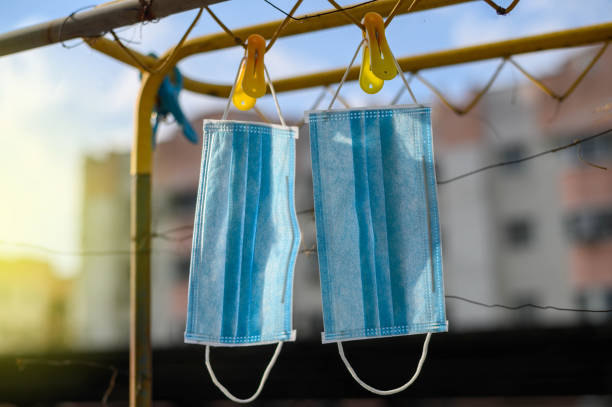 istock Hanging surgical mask under hot sun 1214694453