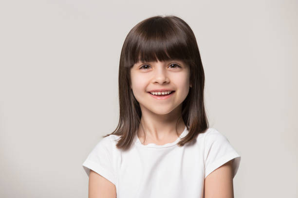 headshot portrait of happy little girl posing in studio - fashion model small one person happiness imagens e fotografias de stock