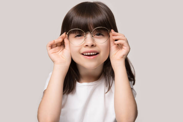 istock Little girl try on wearing spectacles correcting eyesight 1214694464