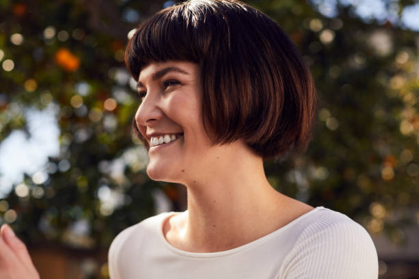 istock Young woman laughing while standing in her yard on a sunny afternoon 1214694472