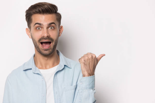 istock Shocked Caucasian man point at blank copy space 1214694502