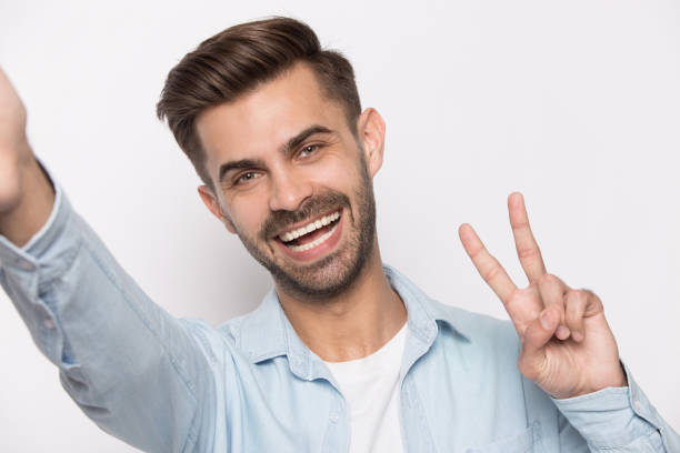 istock Smiling caucasian man making selfie on gadget 1214694524