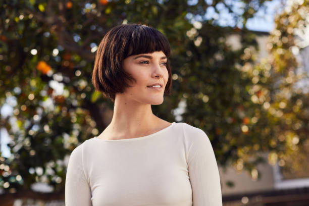 Sporty young woman smiling while standing in her backyard