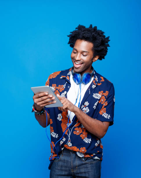 Smiling man in hawaiian shirt holding digital tablet