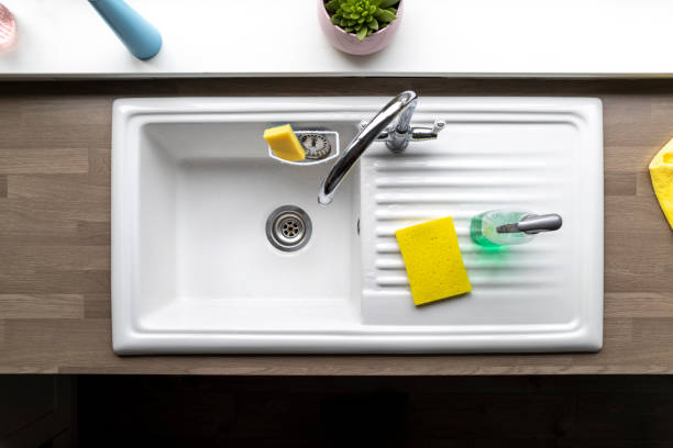 Kitchen Sink A directly above shot of a clean kitchen sink, a sponge and washing up liquid can be seen near by. kitchen sink photos stock pictures, royalty-free photos & images