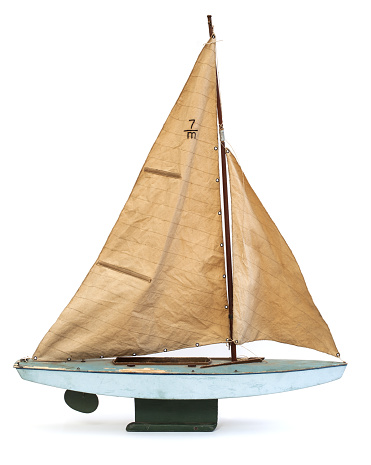 Scale model of old sailboat on white background