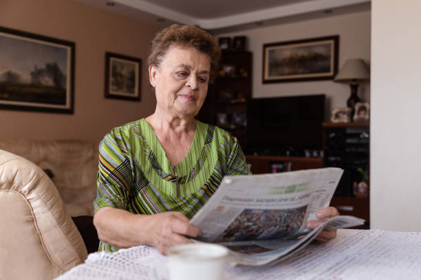 istock Grandmother reading newspapers 1214698870