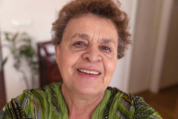 istock Happy elderly woman taking selfie 1214699057