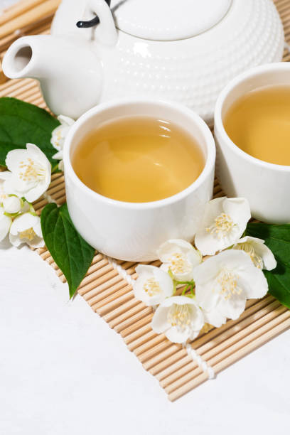 istock japanese tea ceremony. green tea with jasmine, vertical closeup 1214699509
