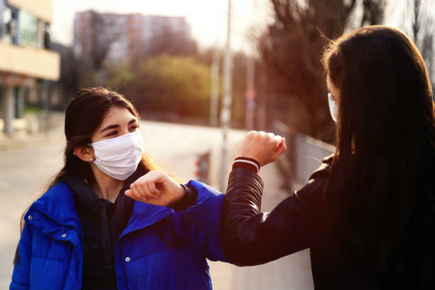 istock Two friends greeting during pandemic 1214701841