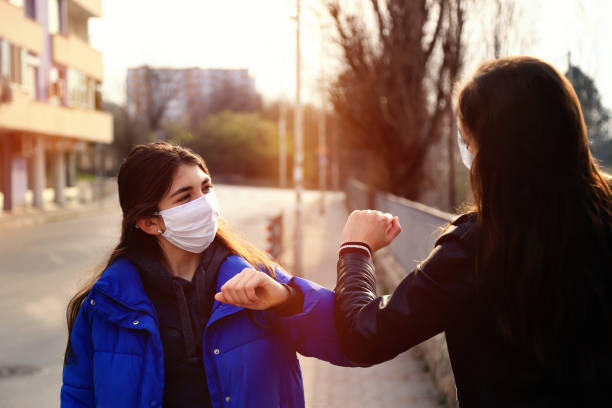 istock Two friends greeting during pandemic 1214701867